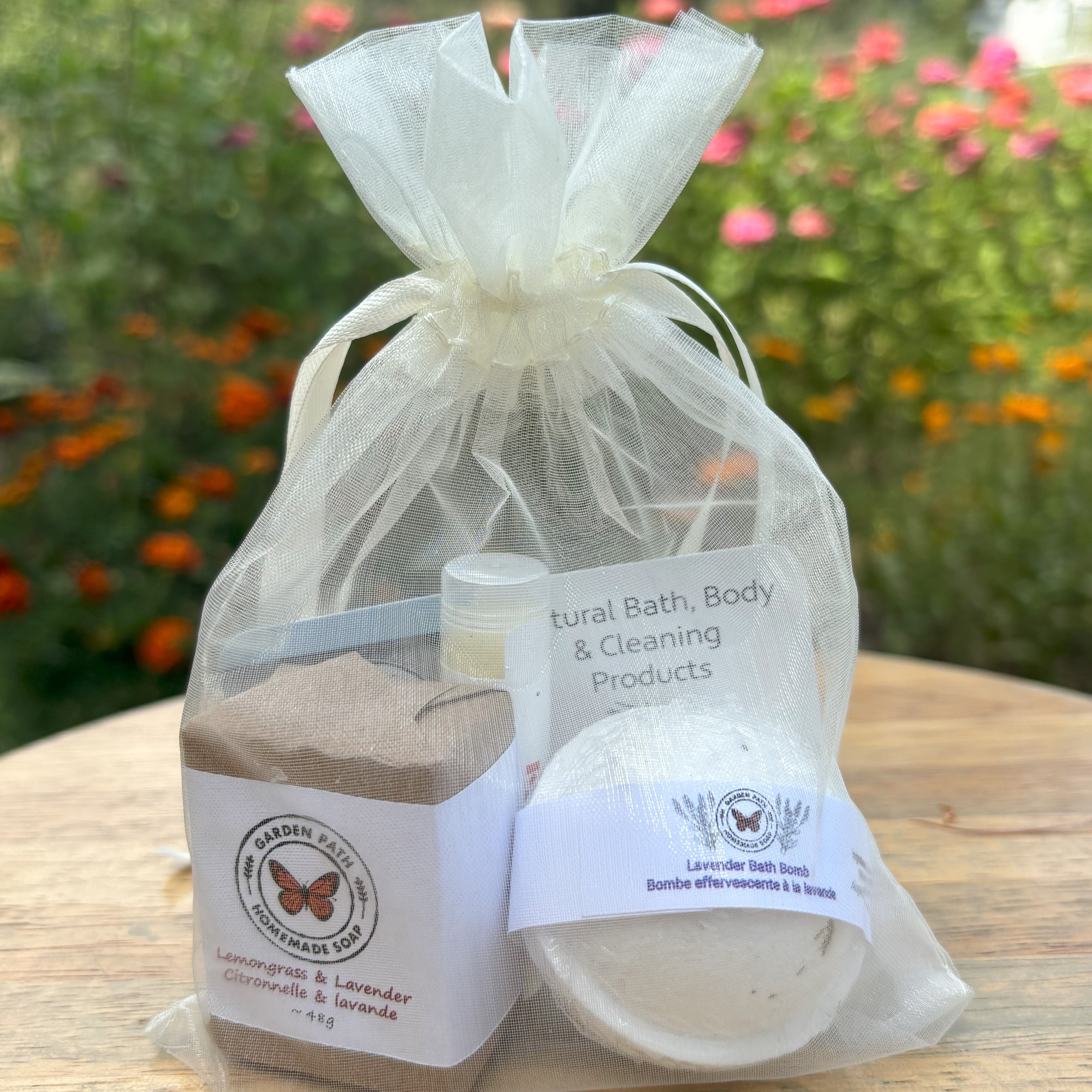 Mini Gift Bundle from Garden Path Homemade Soa in a white organza bag. Bundle contains mini soap bar, bath bomb and lip balm.