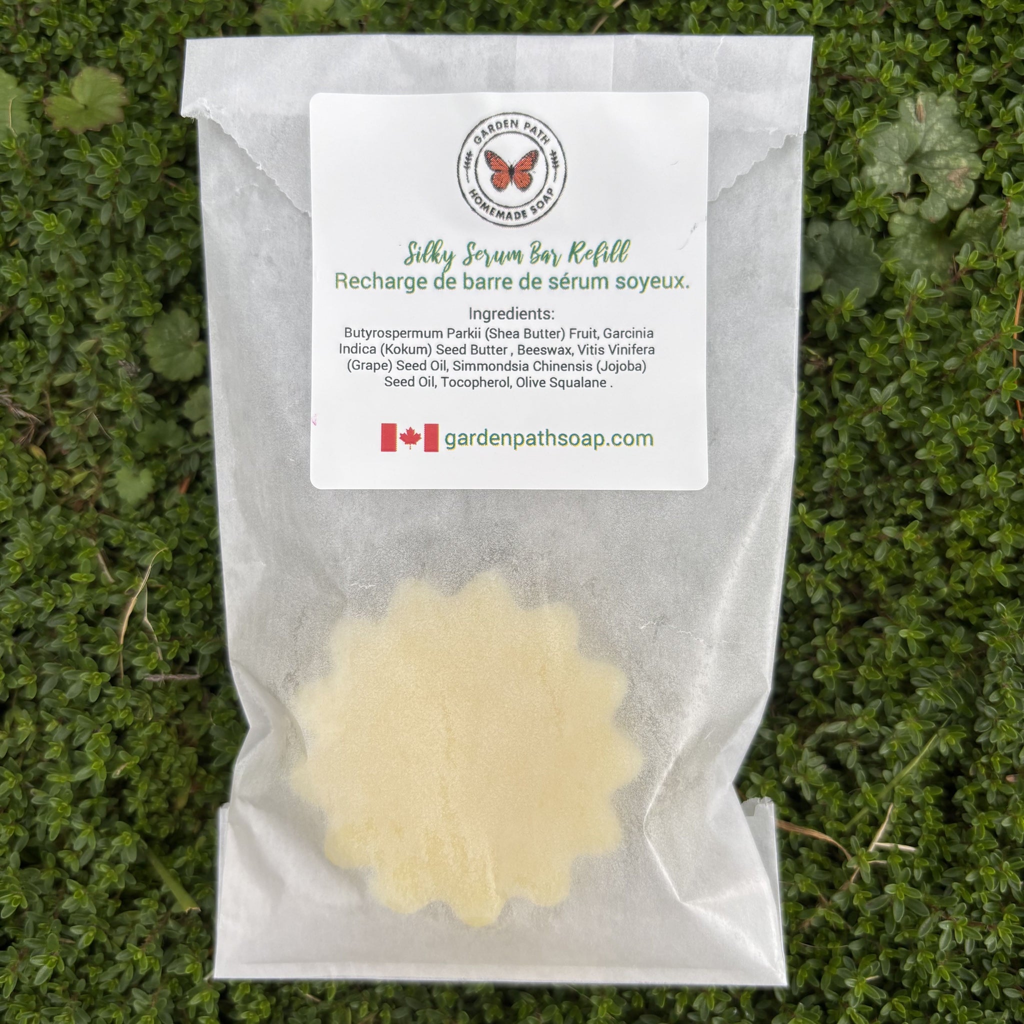 Silky Serum Bar Refill packaging with a label on a grass background