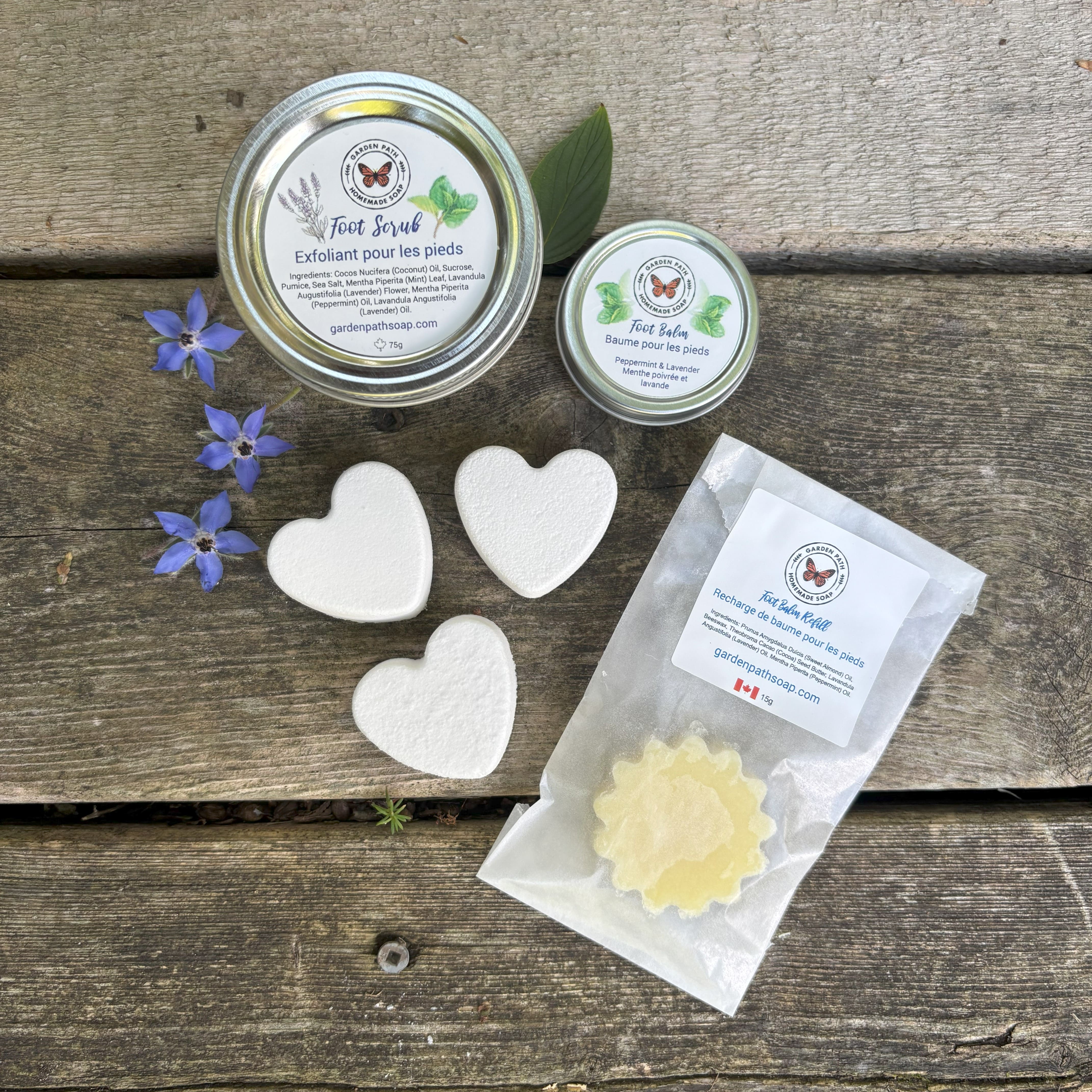 Treat Your Feet bundle by Garden Path Homemade Soap containing foot scrub, 3 foot fizzes, foot balm tin and one foot balm replacement in bag.