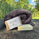 Laundry soap bar with a towel on a wooden surface outdoors