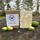 Cucumber Melon Bar of soap wrapped and unwrapped with cucumbers on a wooden surface outdoors. Garden Path Homemade Soap