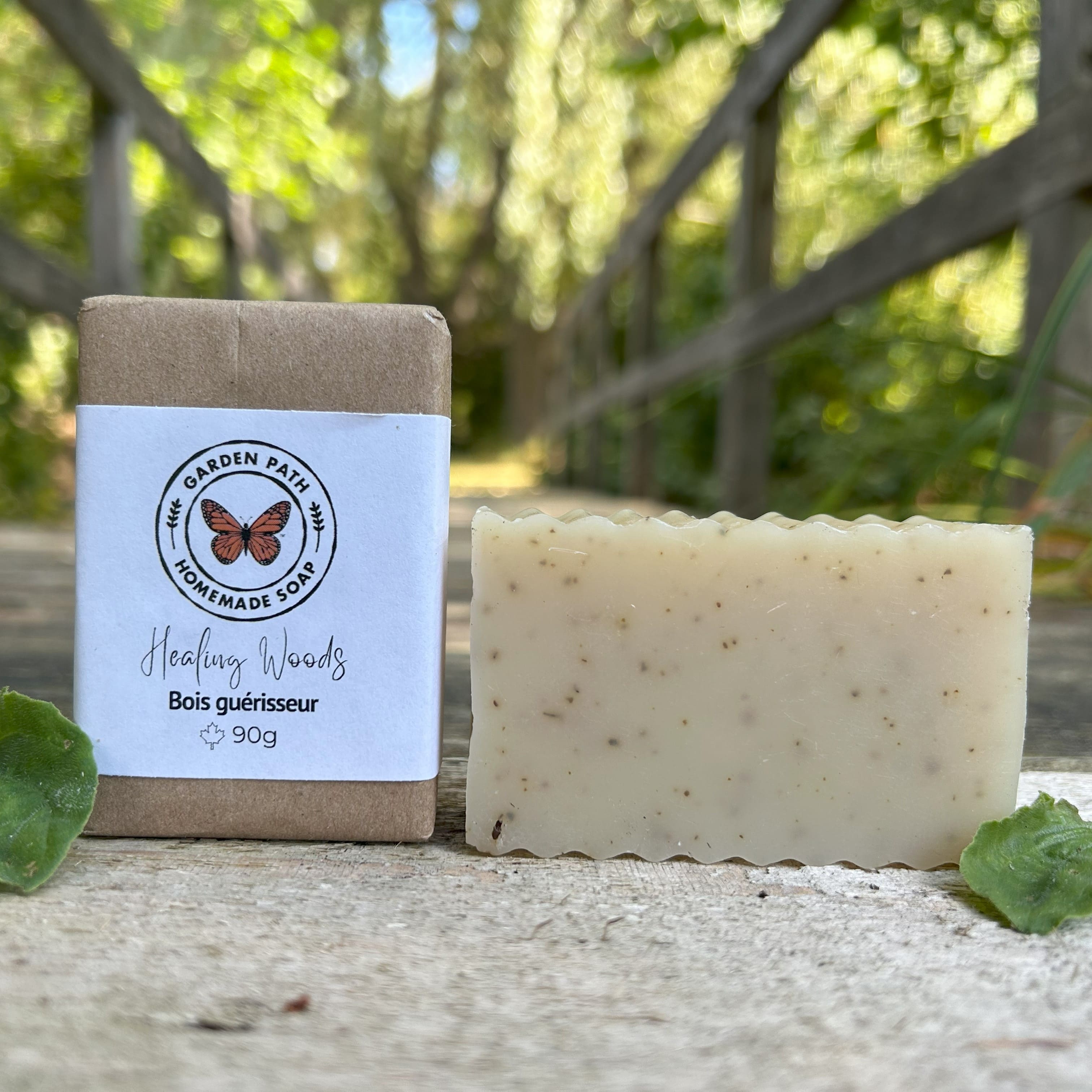 Healing Woods bar of soap both wrapped and unwrapped with plantain  leaves on a natural surface with greenery as the background. Garden Path  Homemade Soap . 100% Natural Essential Oil & Ingredients