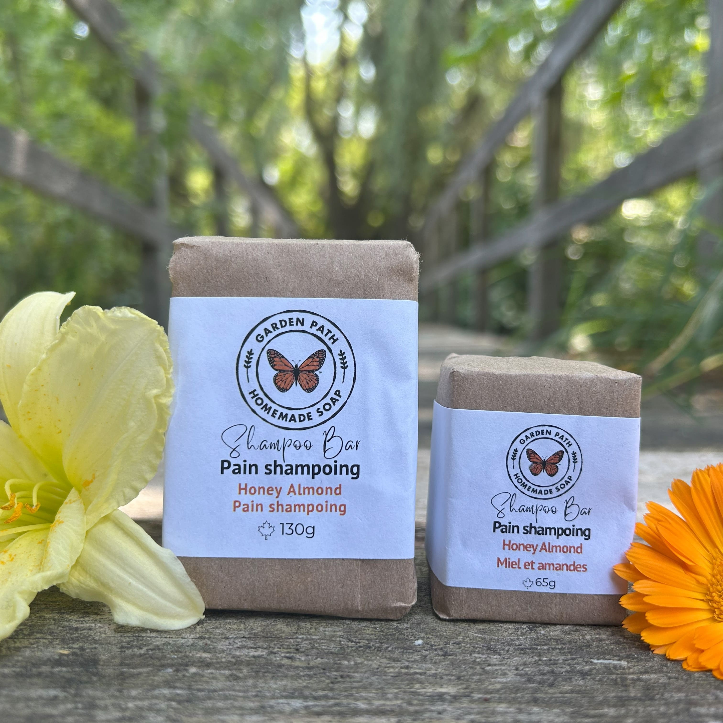 Honey Almond Shampoo Bar, both large and small, in an outdoor natural setting with yellow and orange flowers beside | Lightly Scented Honey Almond Fragrance | Made with Beer - Garden Path Homemade Soap