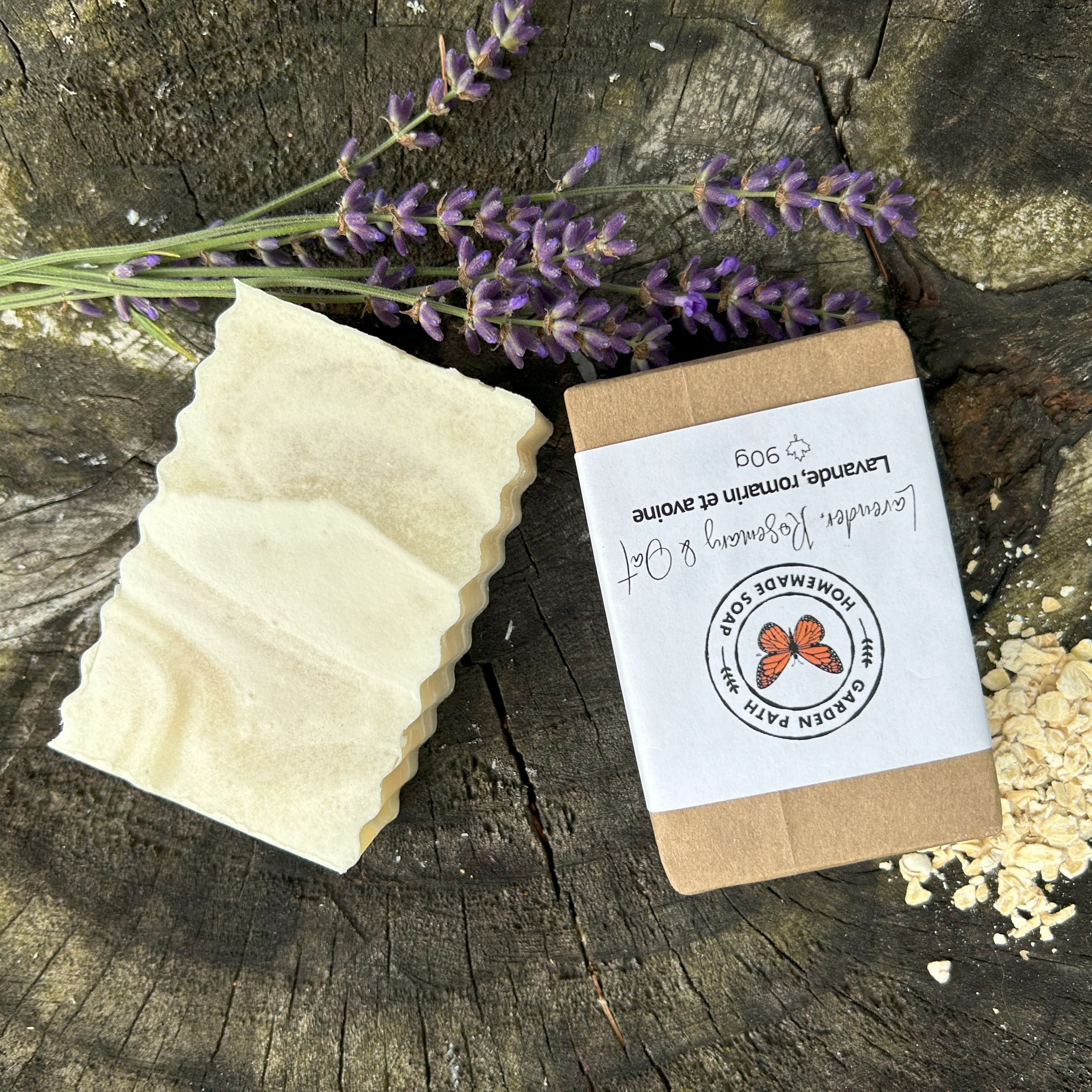 Lavender, Rosemary & Oats Bar Soap on a wooden surface with oatmeal flakes and lavender flowers | 100% Natural Exfoliating Soap with Essential Oils - Garden Path Homemade Soap