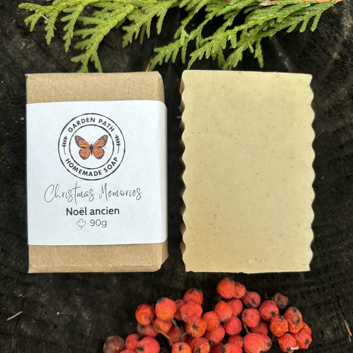 Christmas Memories Bar of soap with packaging and greenery and red berries on a dark surface