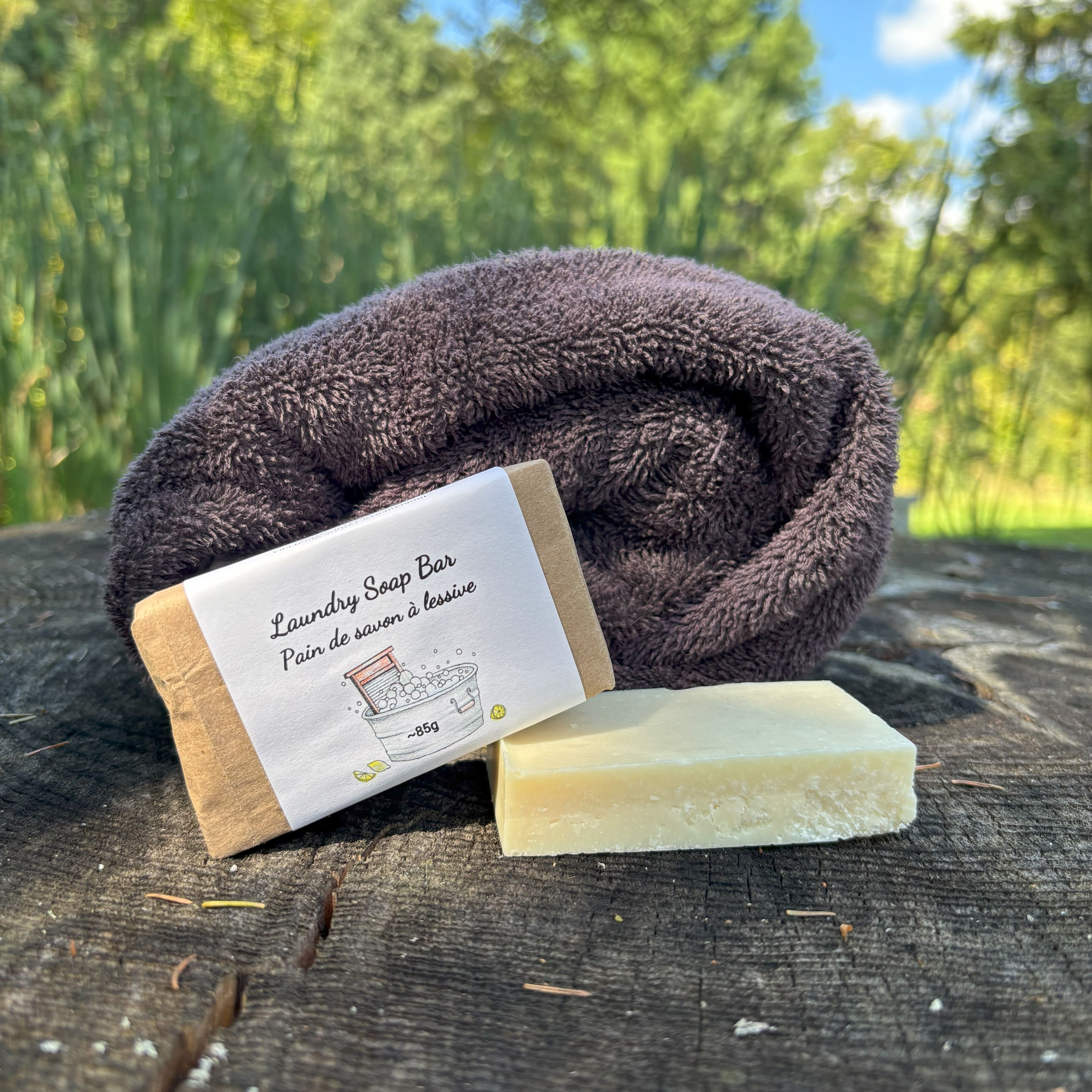Laundry soap bar with a towel on a wooden surface outdoors