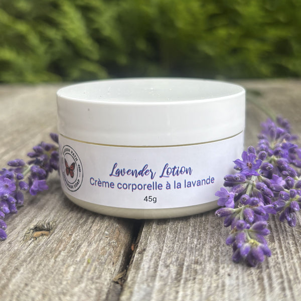 white lotion jar surrounded by purple lavender flowers on wood