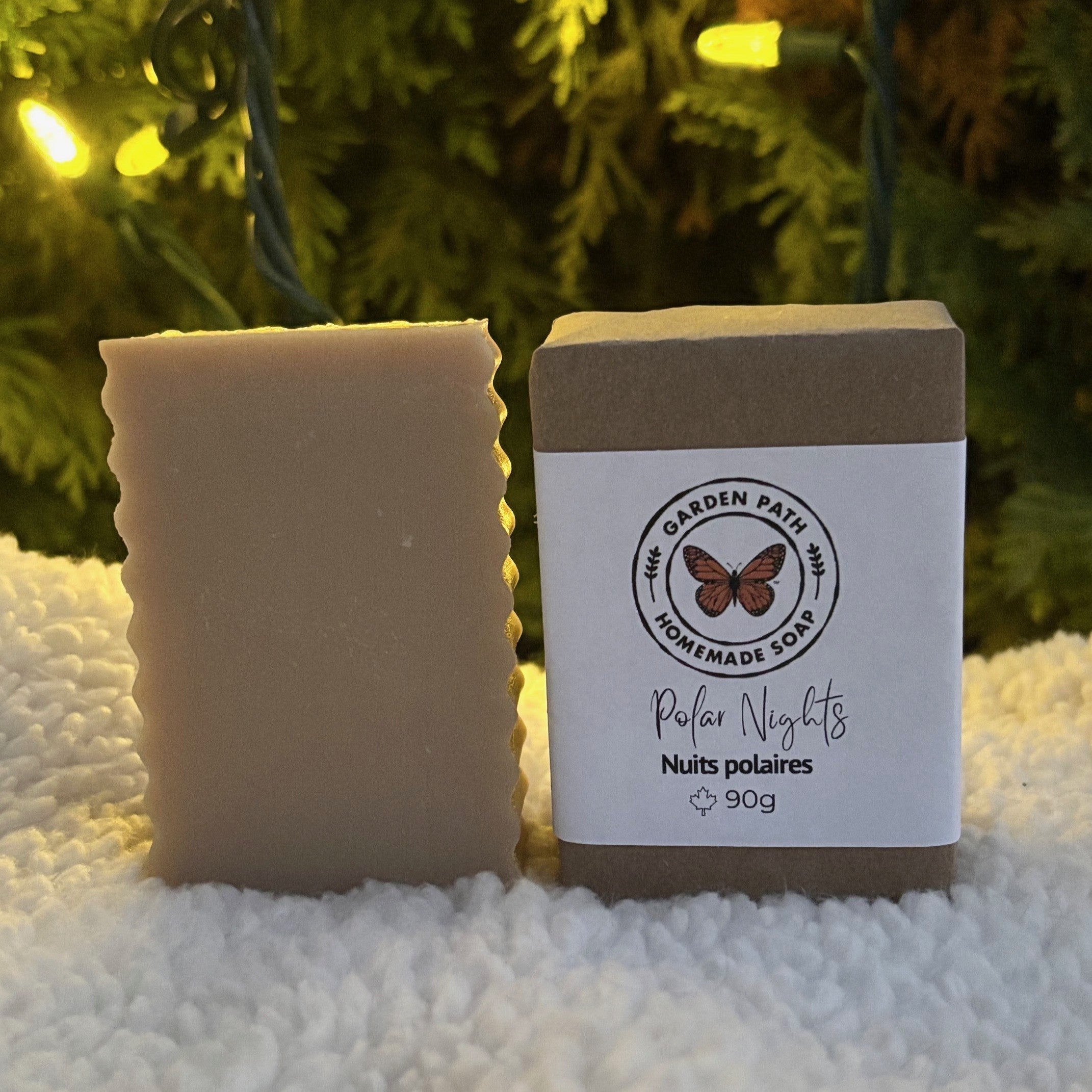 Polar Nights Bar Soap (limited time) on a white snowy surface with Chrismas lights in the back ground | Lightly Scented with Fragrance Oil - Garden Path Homemade Soap
